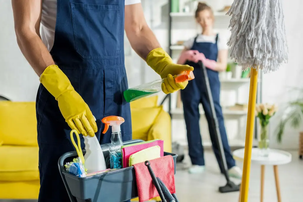 Cleaner with spray bottle and gloves ready for an after builders clean in Maidstone