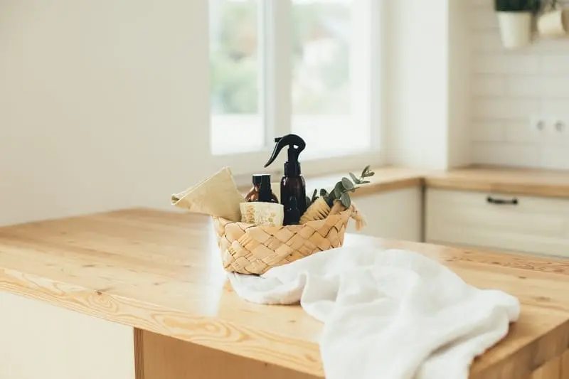 Basket of eco-friendly cleaning products on a kitchen worktop in a Kent home