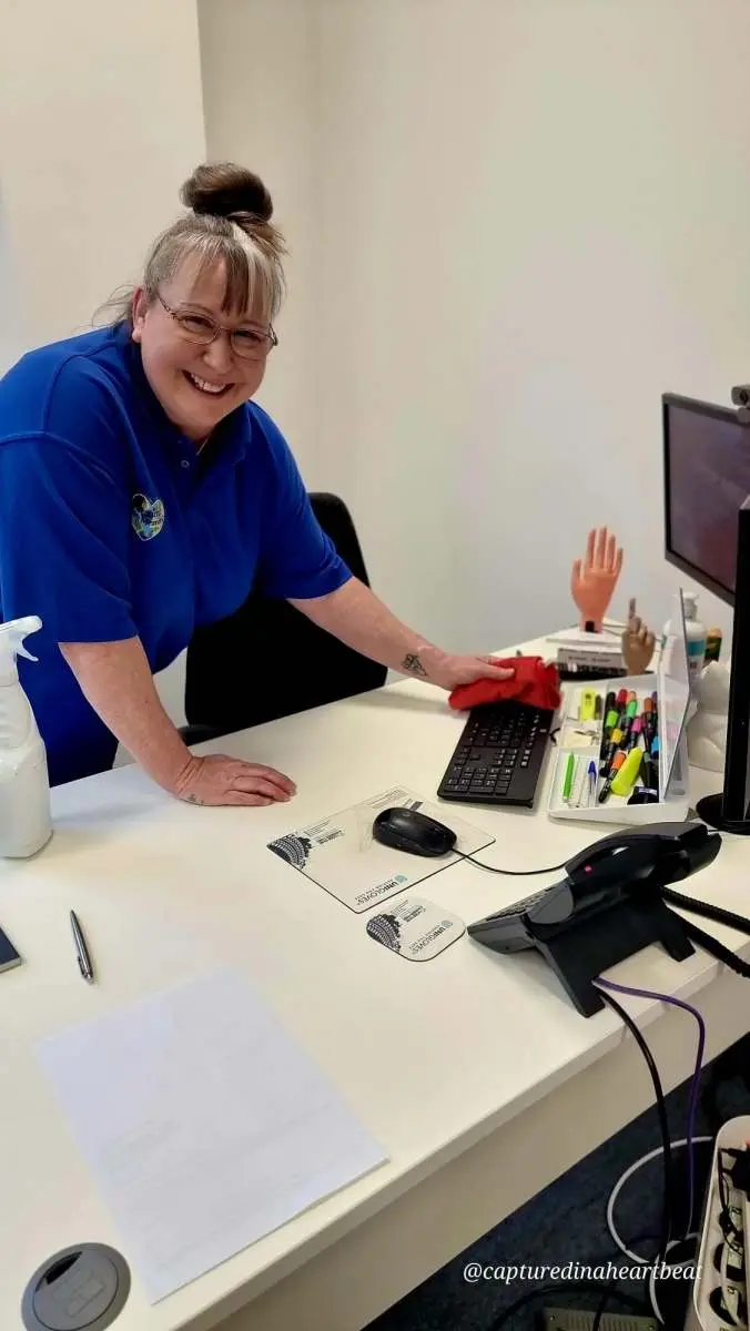 Cleaning With Meaning cleaner wiping down an office desk in Maidstone