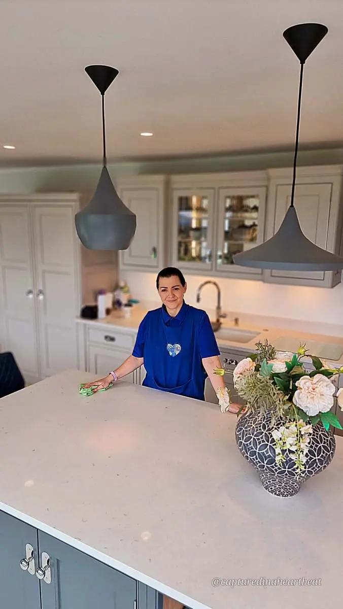 Cleaning With Meaning team member cleaning a kitchen worktop in Maidstone